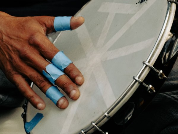 A hand playing a pandeiro